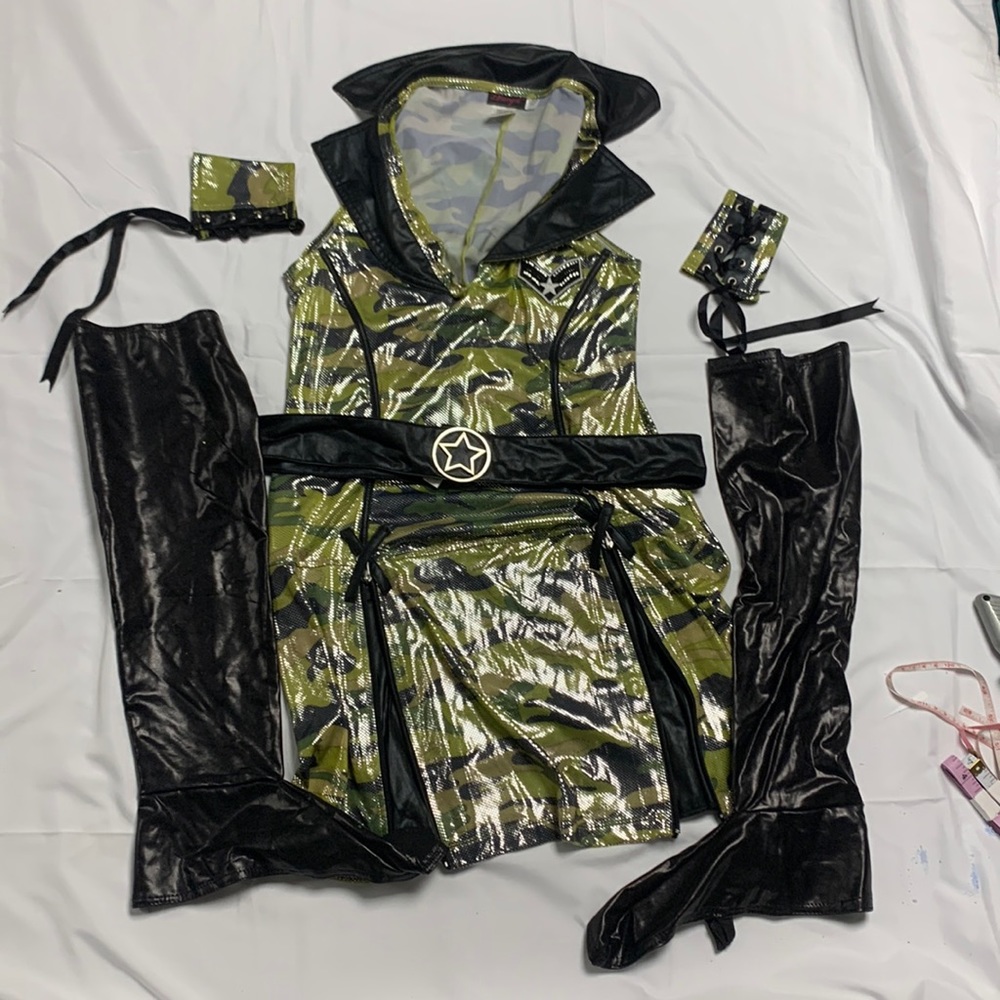 Womens army cadet costume includes belt shoe covers and wrist accessories.
